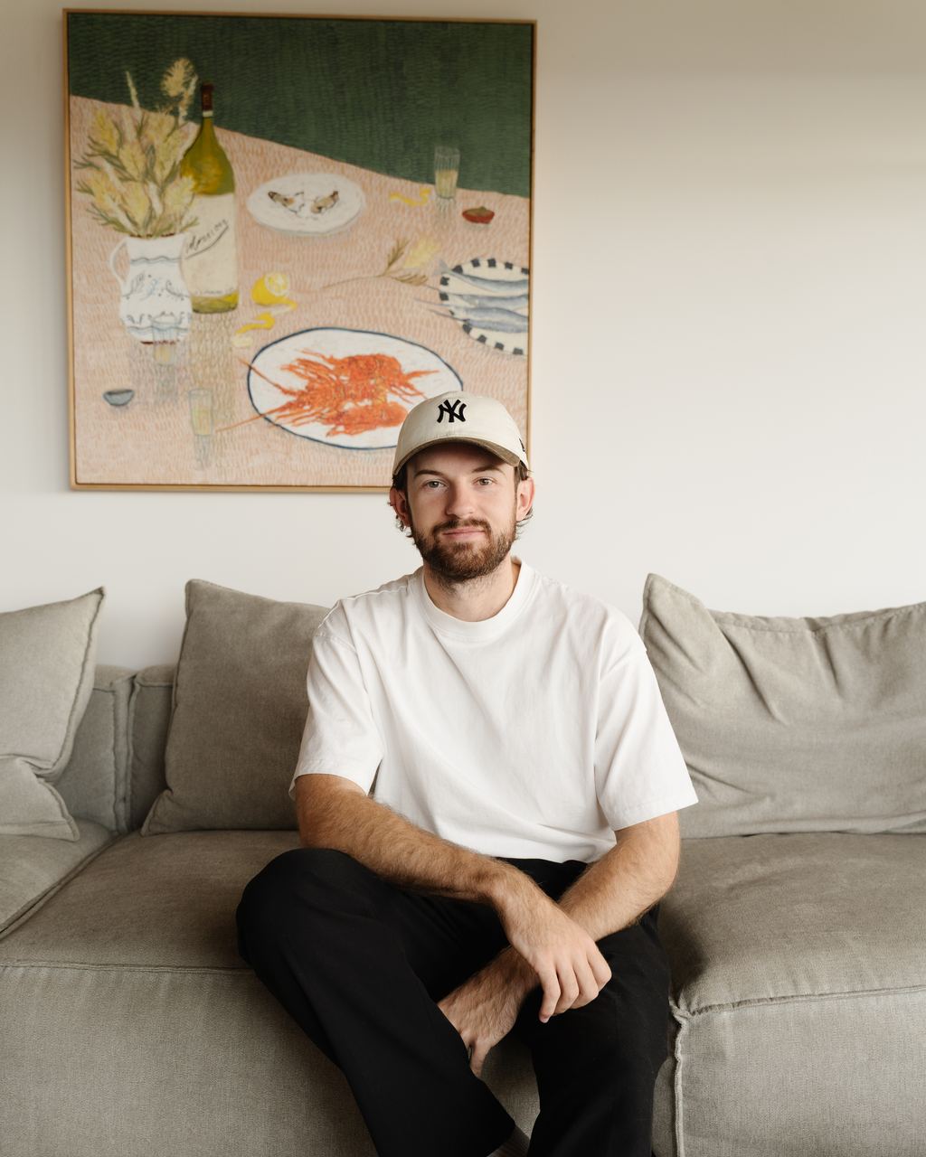 Ethan, the photographer and filmmaker behind isforeverfilms, sitting on a couch at home
