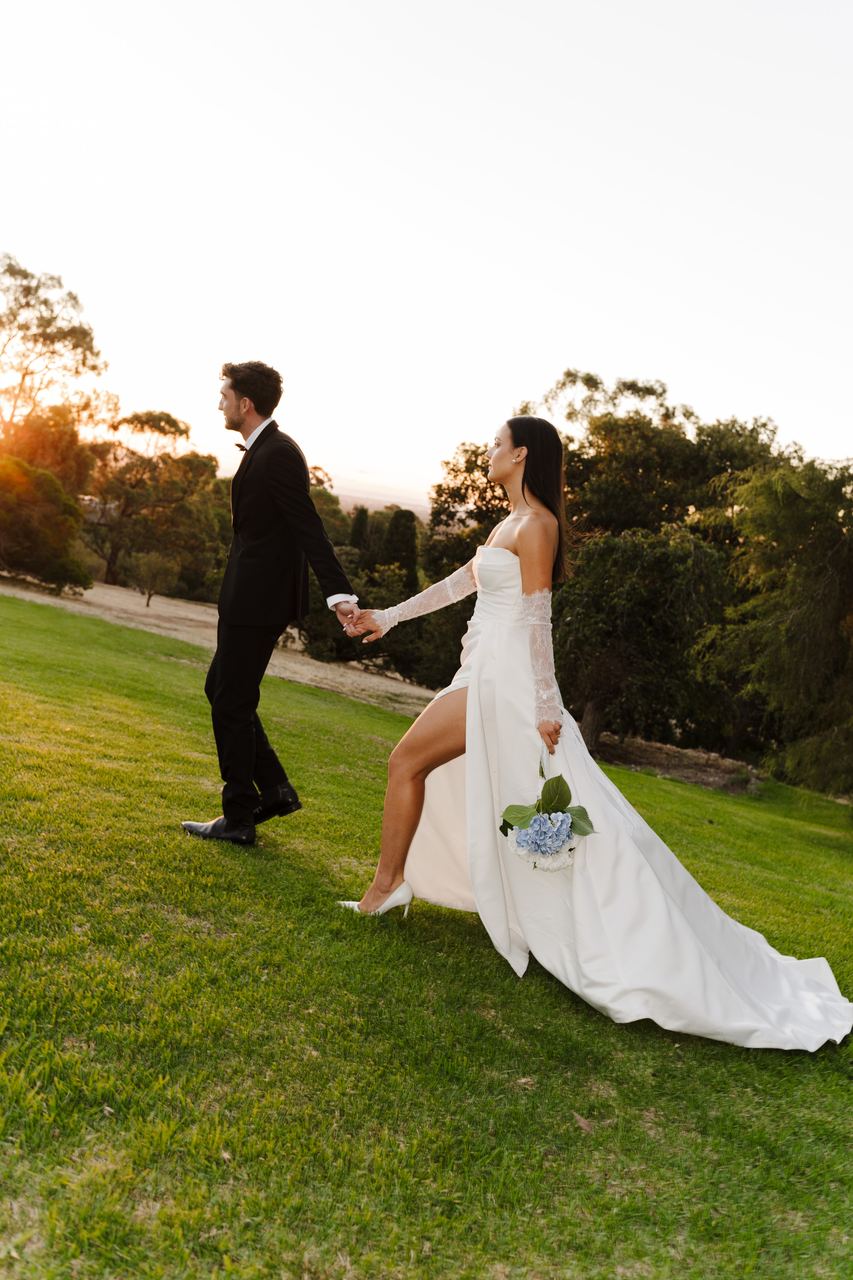 Ben and Cameron walking across the lawn at sunset