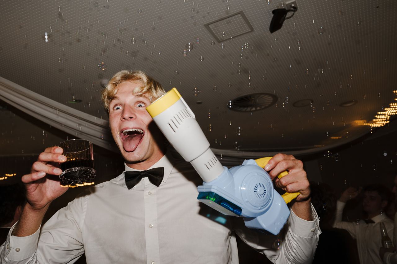 A guest firing a bubble gun on the dance floor