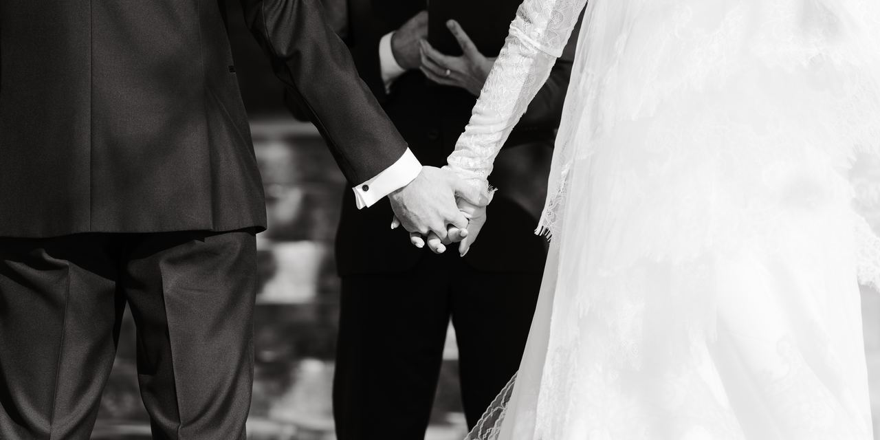 Ben and Cameron holding hands at the altar