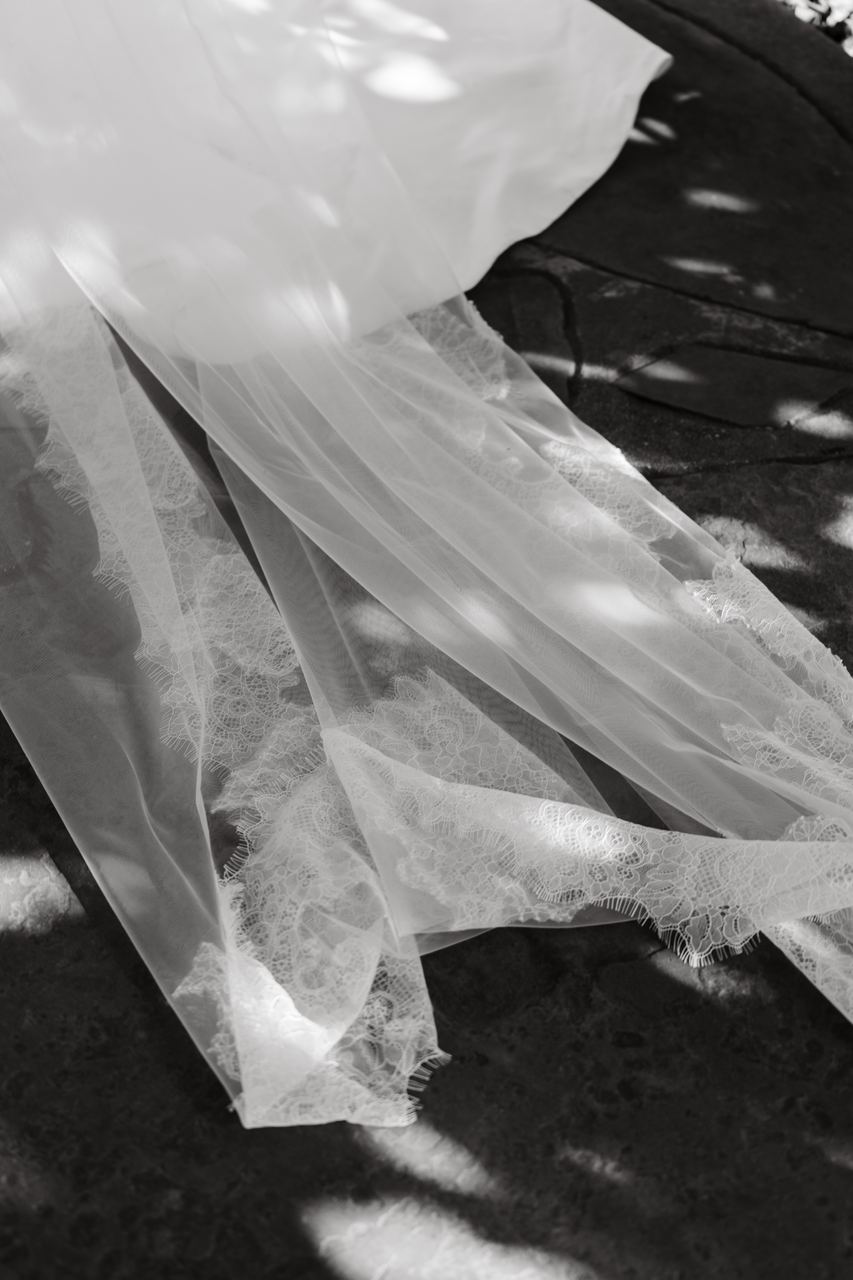 The veil trailing across the grass