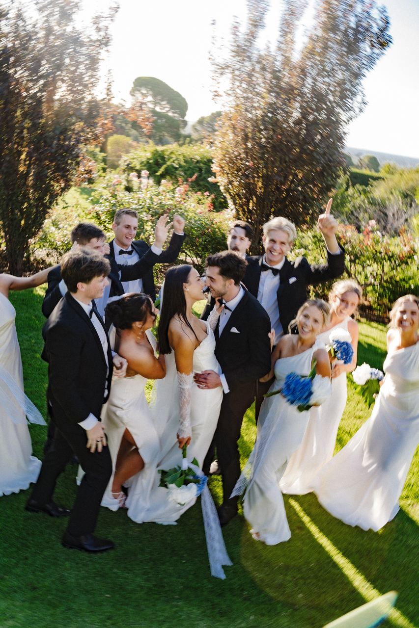 Ben and Cameron kissing in the middle of the wedding party