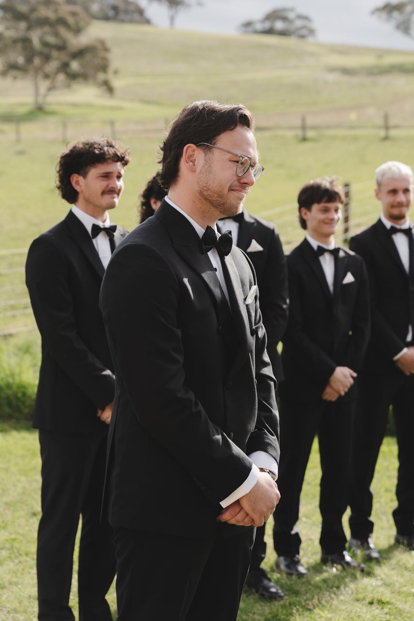 Waiting at the end of the aisle with the groomsmen
