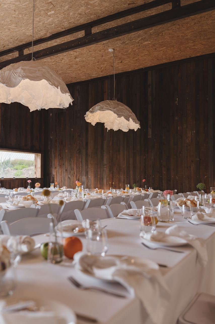 The long tables set in the barn