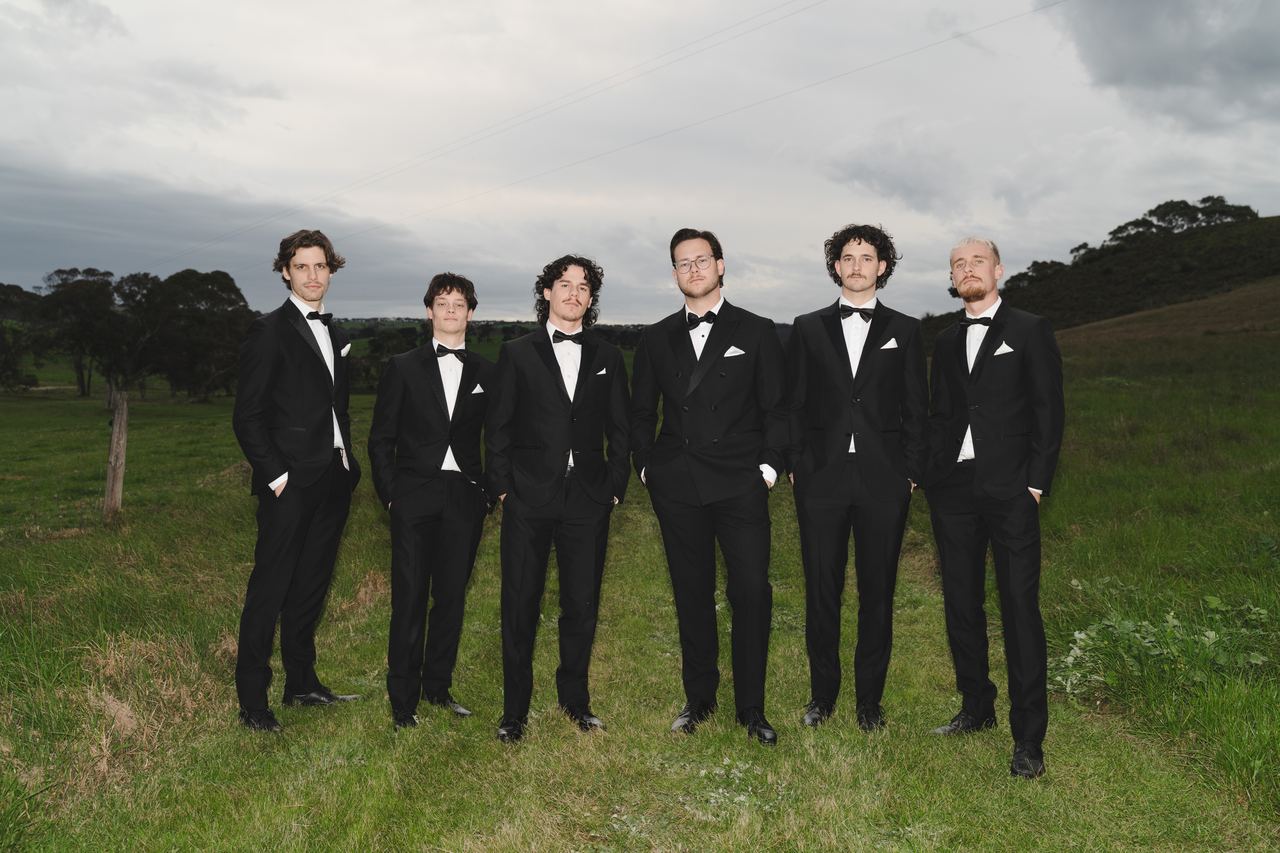 The groomsmen lined up in the paddock