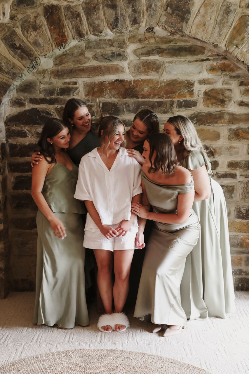 Lily and the bridesmaids in a stone doorway