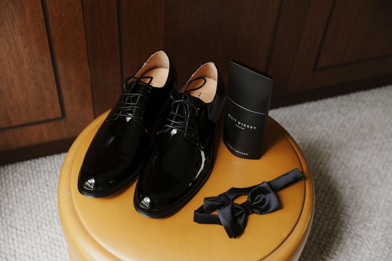 Jason's shoes and bow tie laid out on a stool
