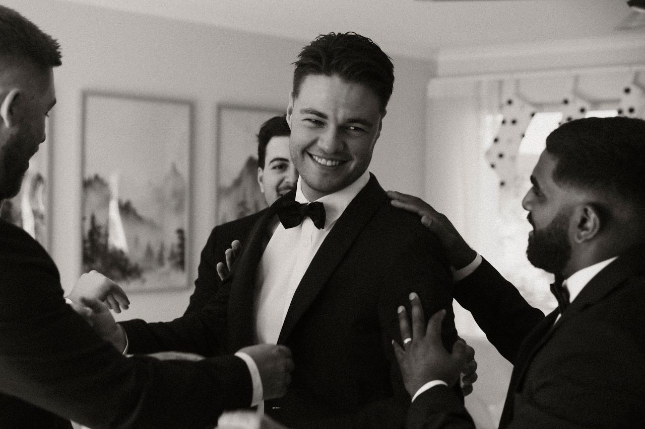 Jason laughing with the groomsmen while getting ready
