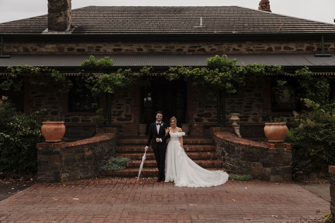 Jason and Lily in front of the stone house