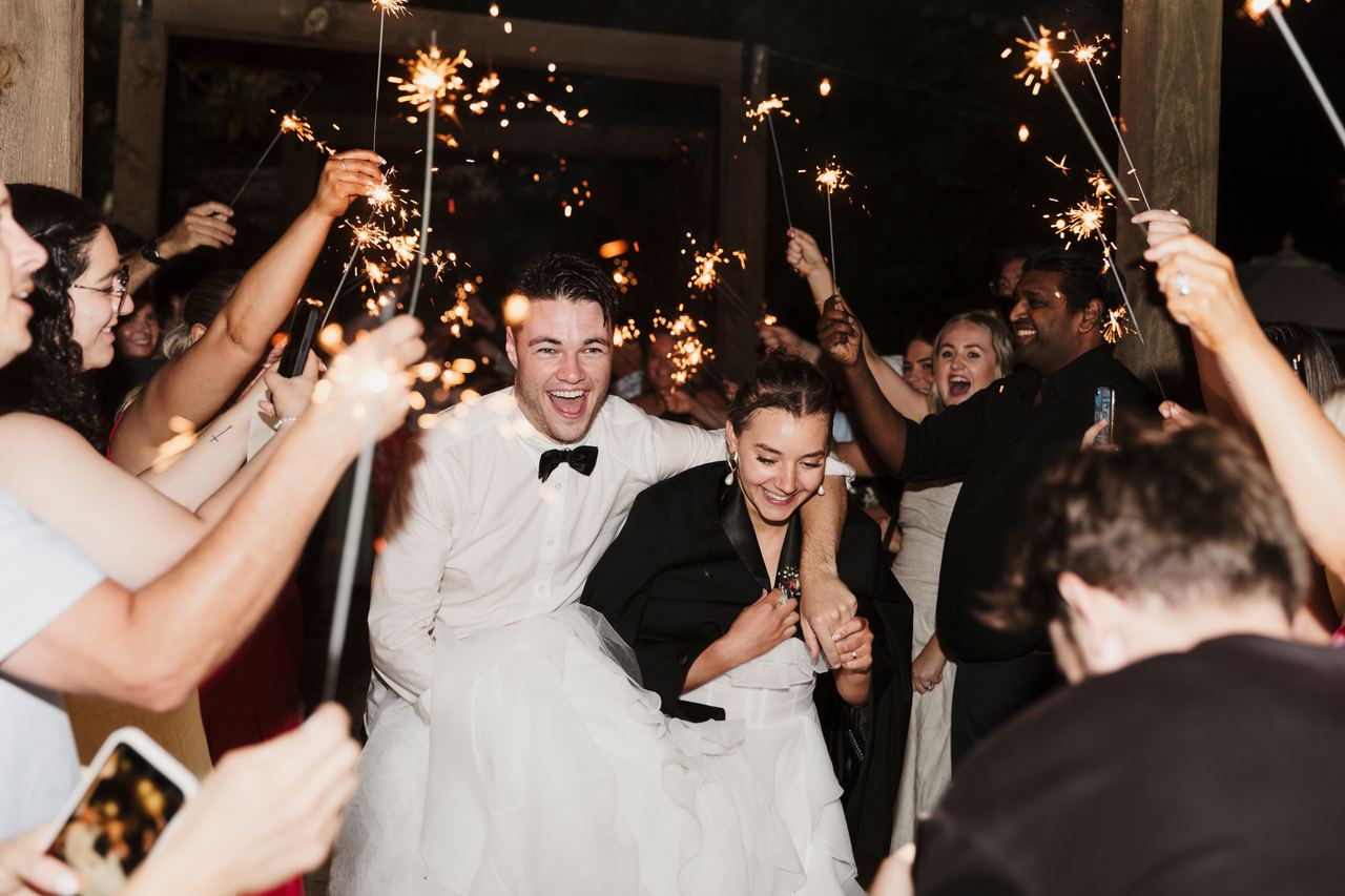 Jason and Lily running through a sparkler exit