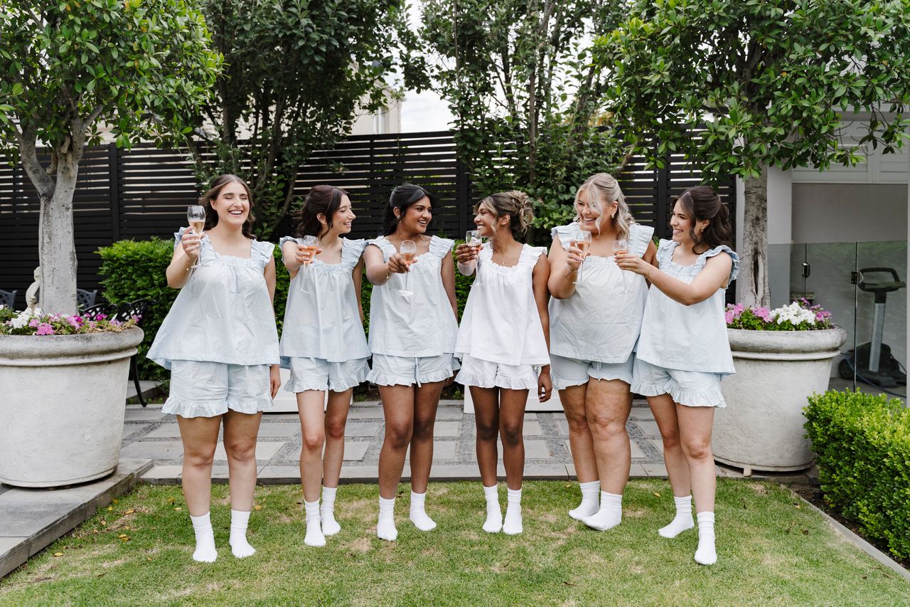 The bridesmaids in matching pyjamas on the lawn