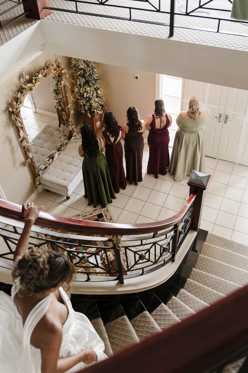 The bridesmaids seeing Sinead's dress from the stairs above