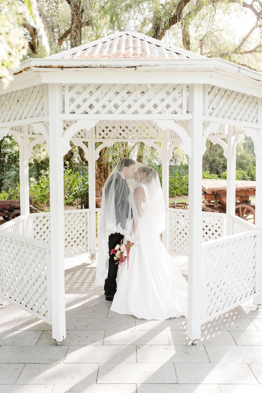Ben and Sinead beneath the veil in the white gazebo