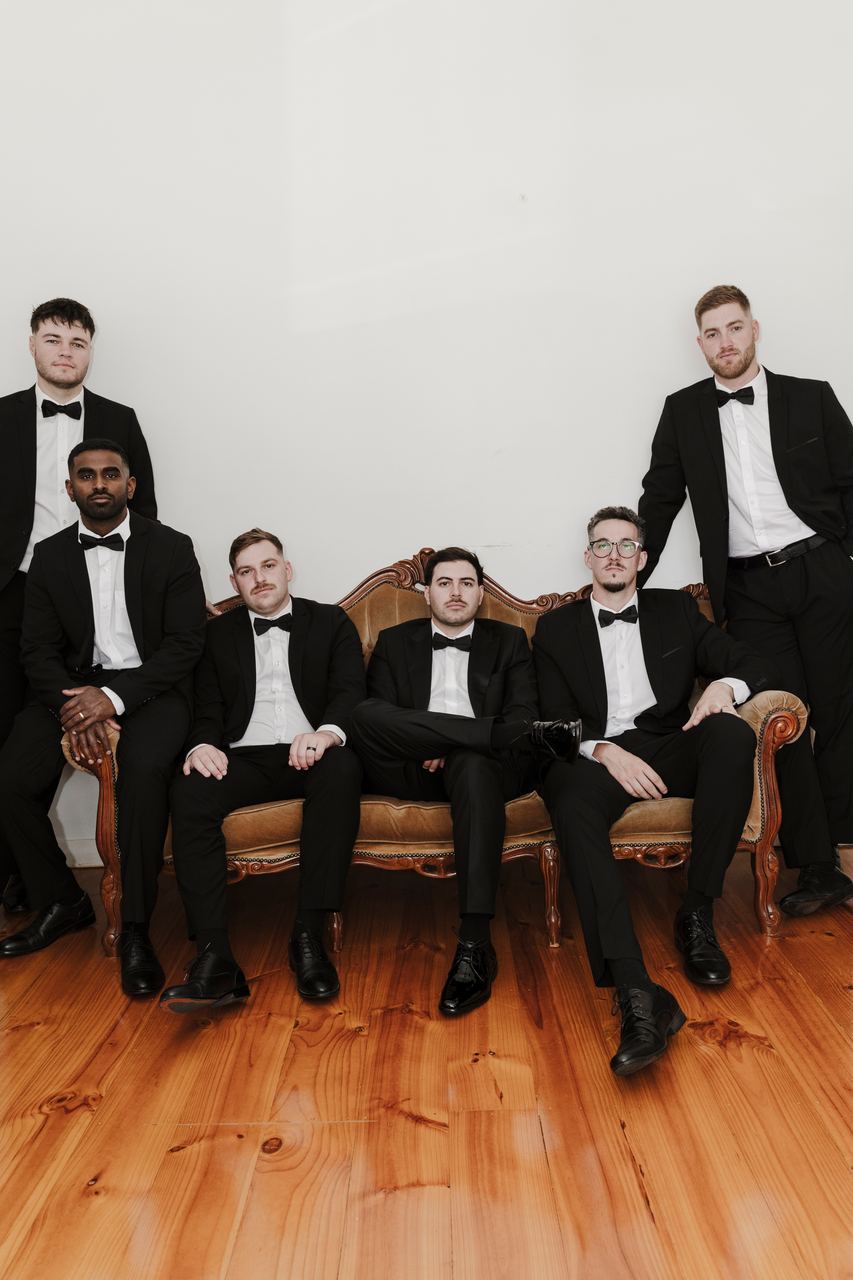 Ben and the groomsmen on a vintage sofa