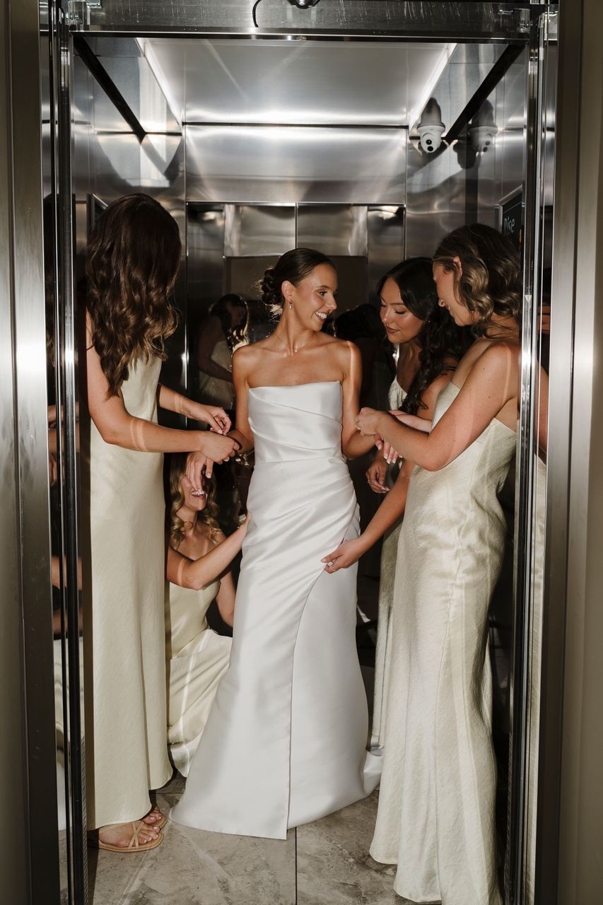 Alex and the bridesmaids crowded into the lift