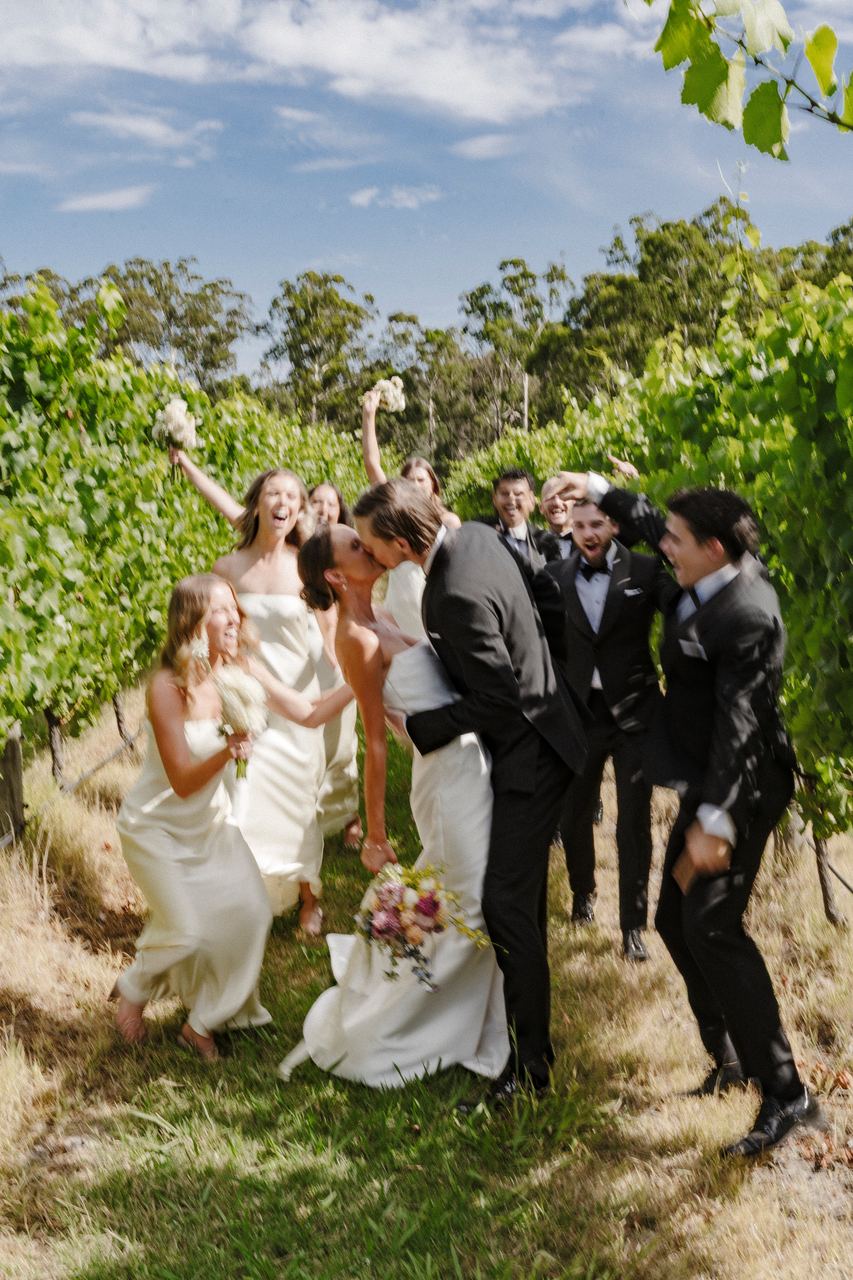 The wedding party celebrating in the vines