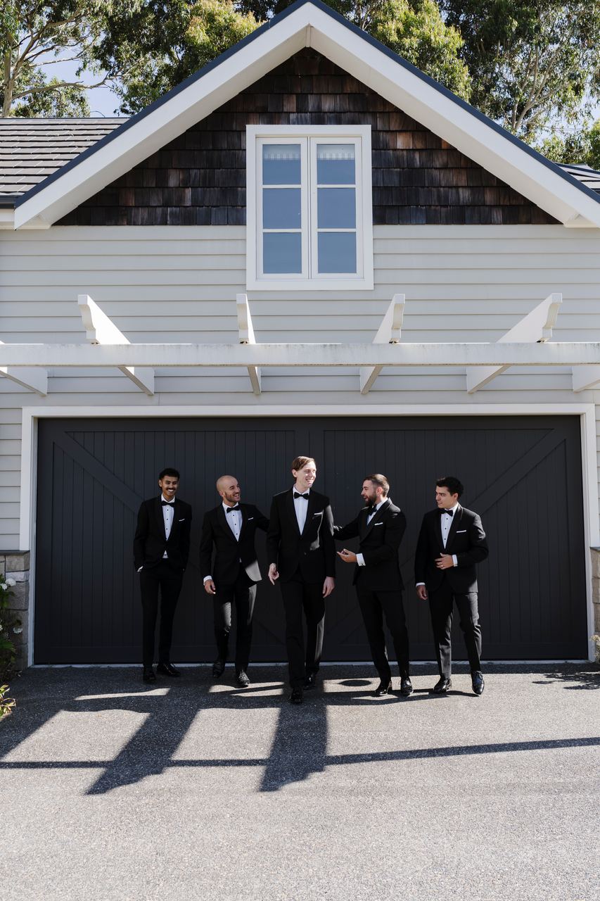 Matthew and the groomsmen in front of the garage