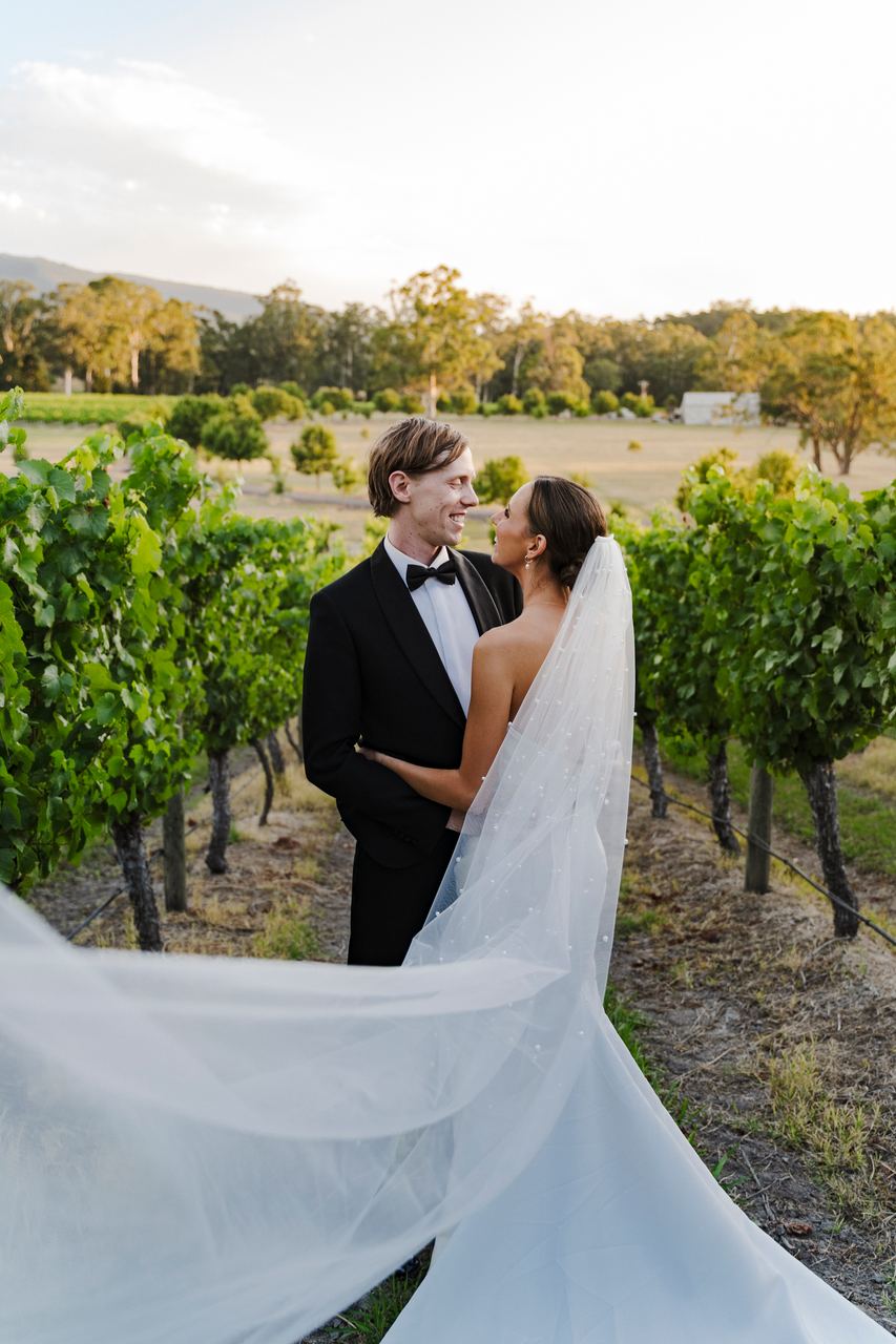 Alex's veil catching the breeze in the vineyard