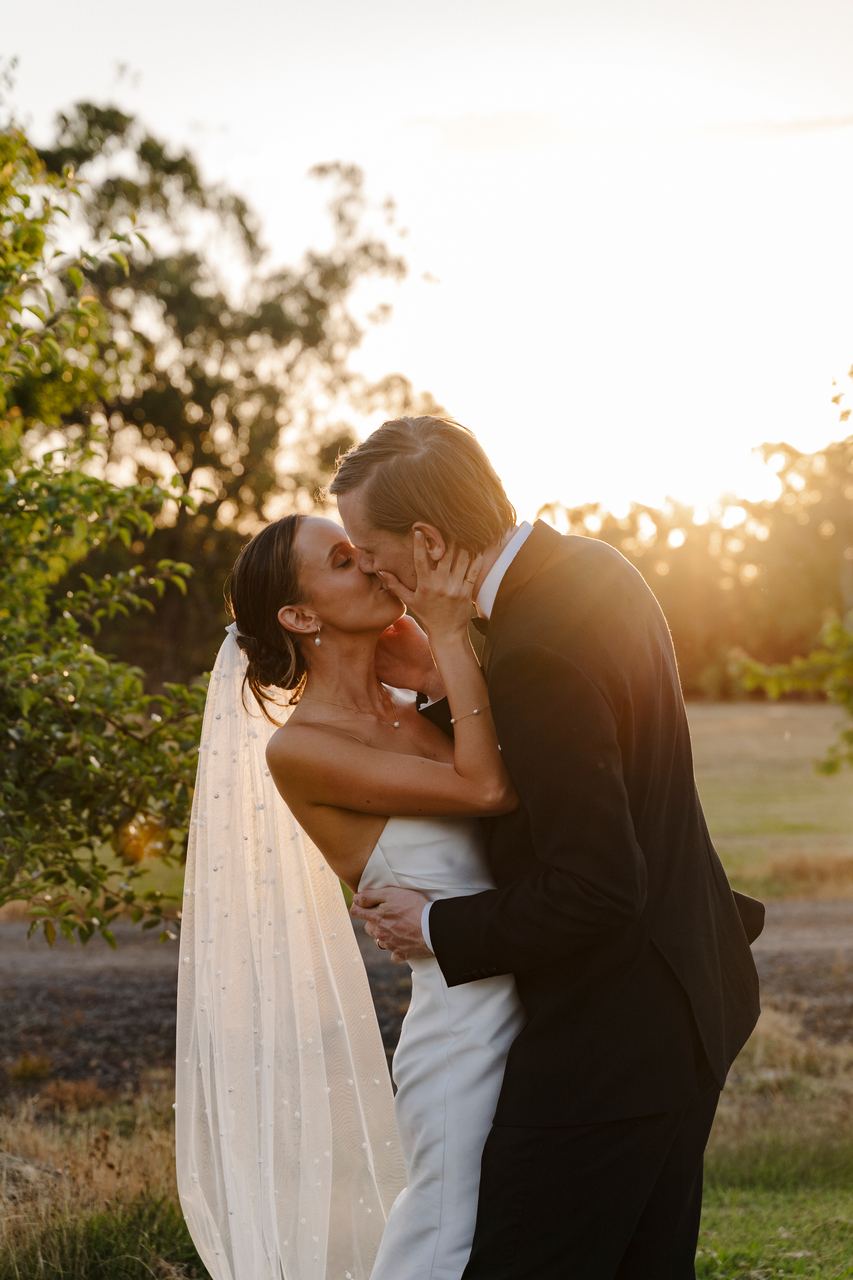 Matthew and Alex kissing in the golden light