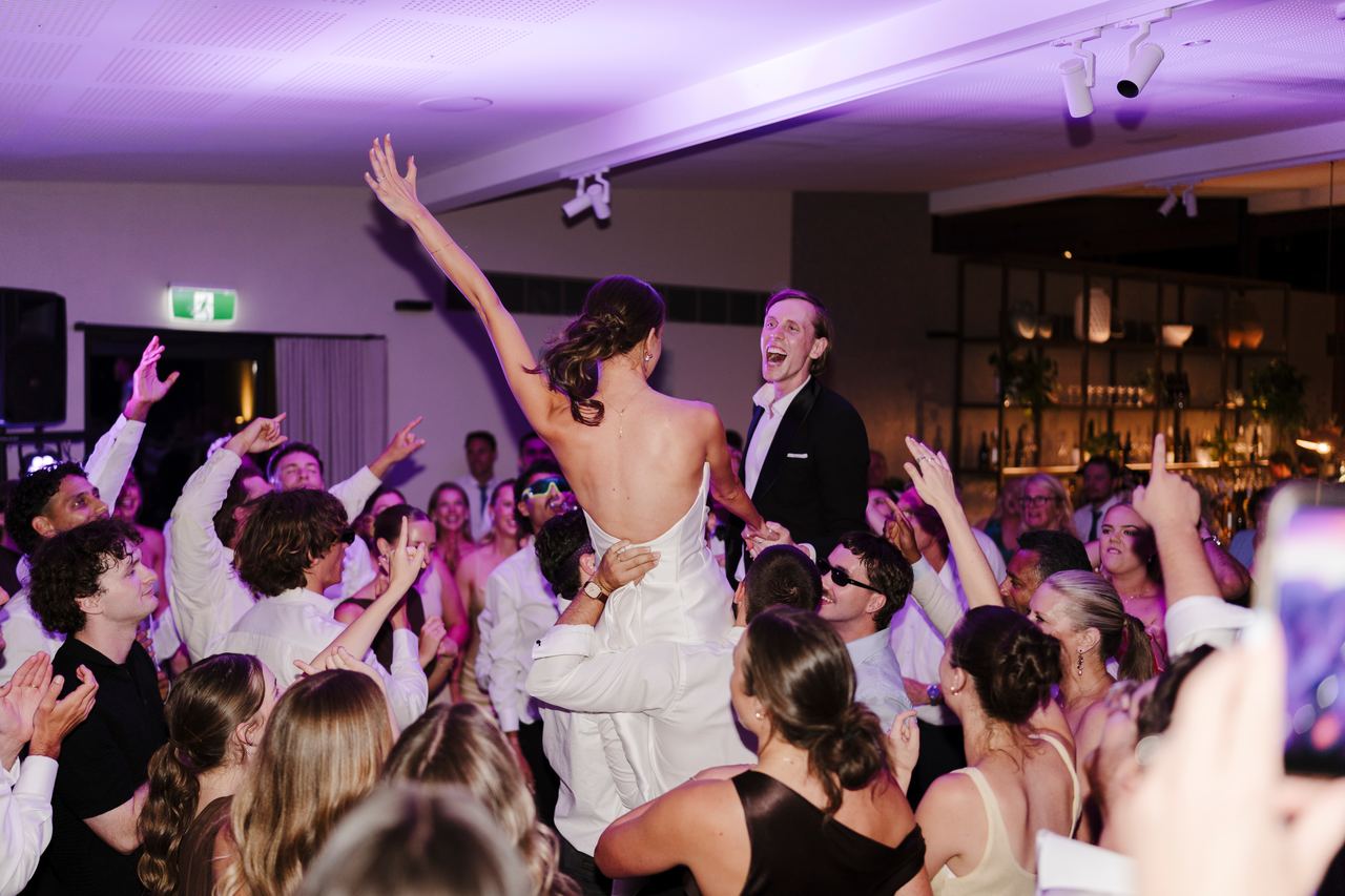 Alex lifted above the crowd on the dance floor