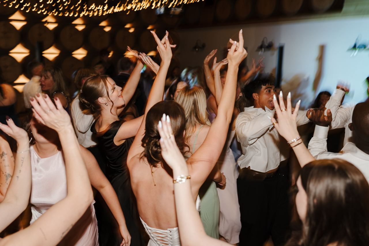 Guests dancing in the barrel room
