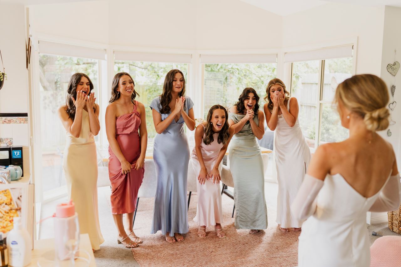 The bridesmaids seeing Georgia's dress for the first time