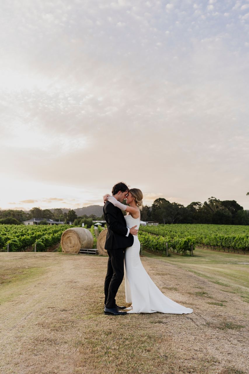 Caleb and Georgia embracing under an evening sky