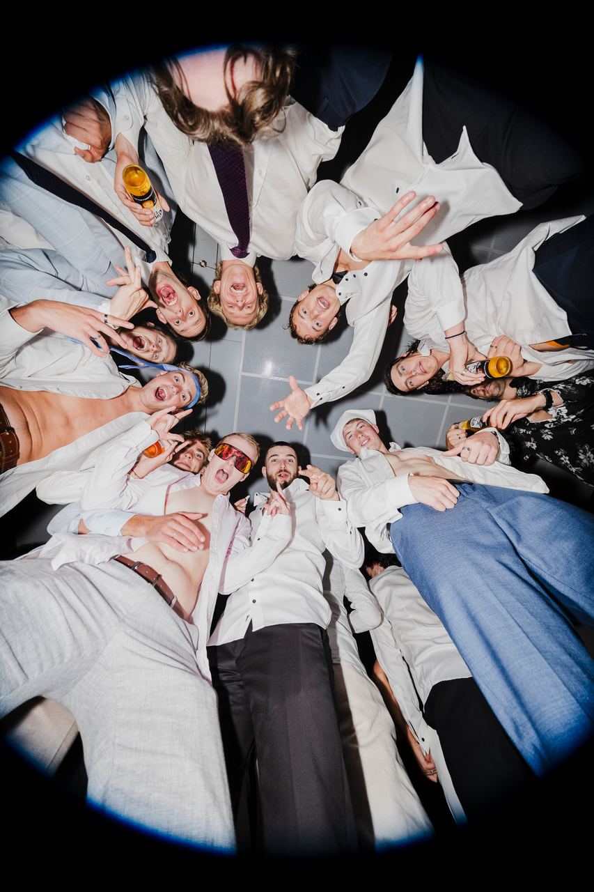 Friends in a circle looking down at the camera