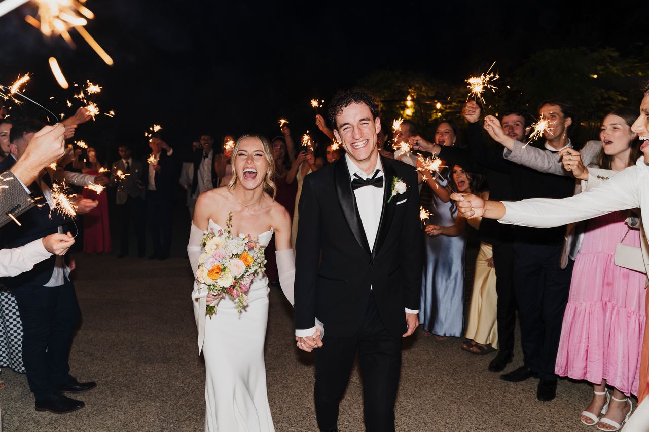 Caleb and Georgia leaving through a sparkler exit